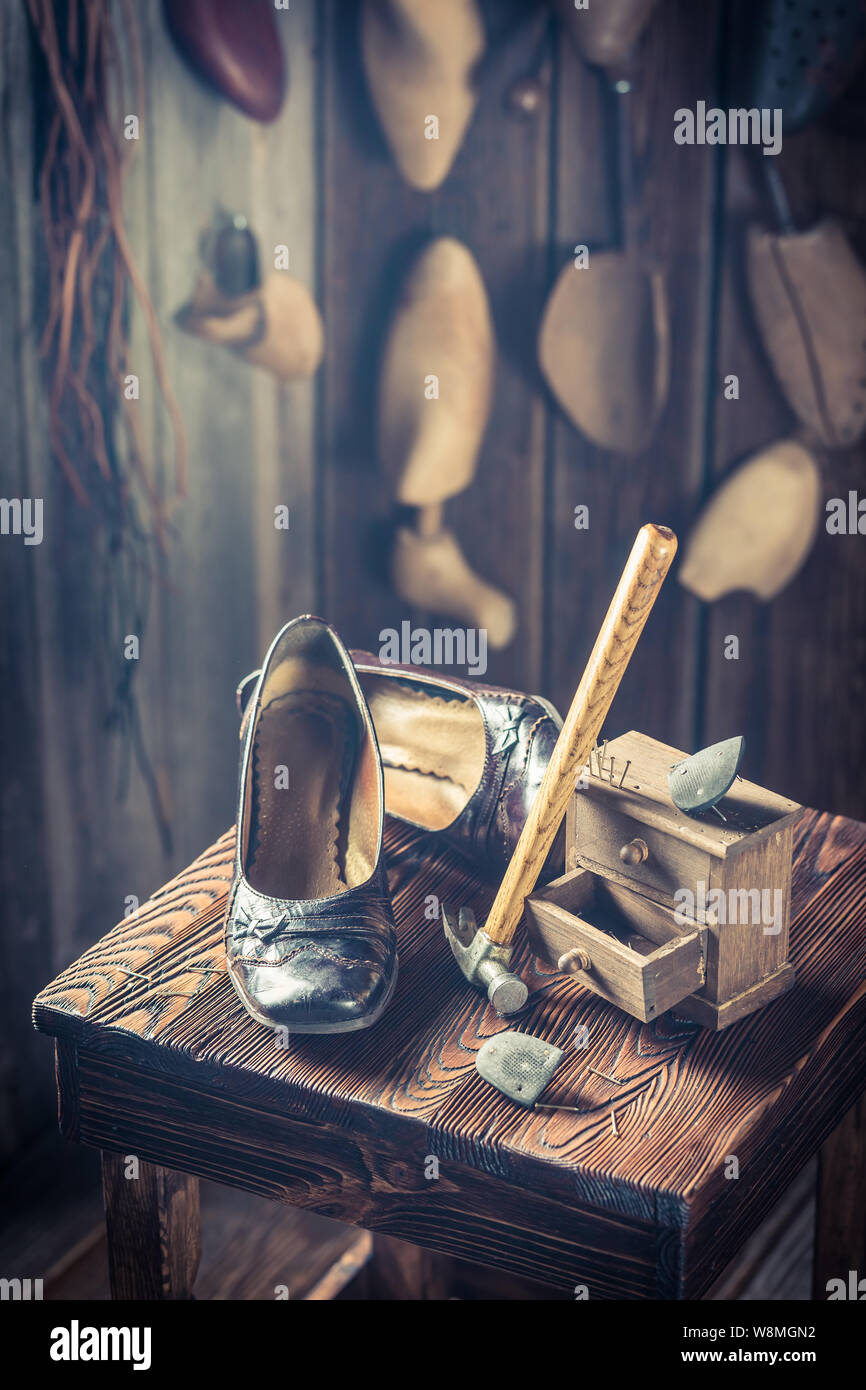 Rustic shoemaker workplace with tools, leather and shoes Stock Photo ...