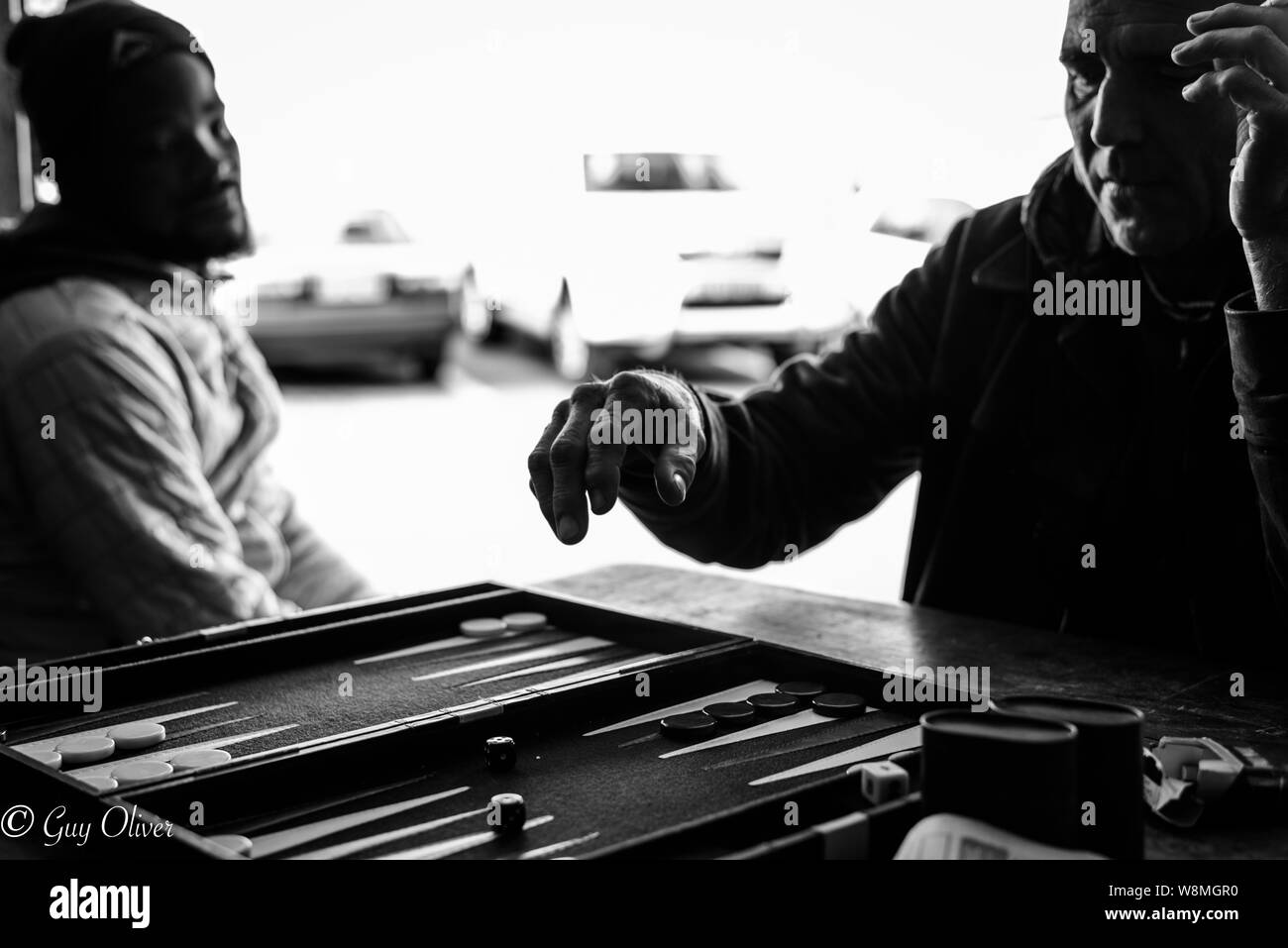 Playing the board game Backgammon on the Cape Peninsula in Glencairn, South Africa, near Cape Town Stock Photo