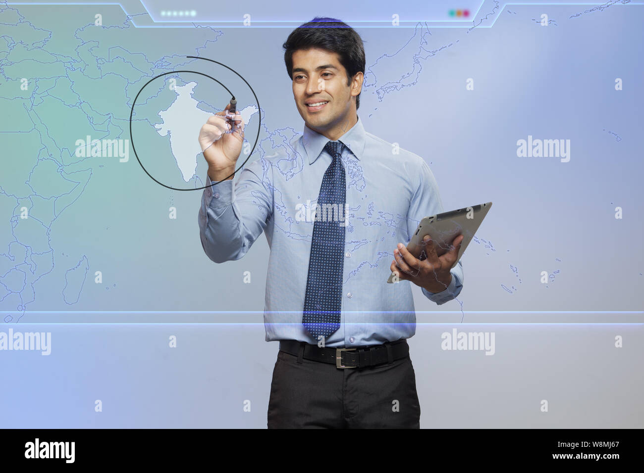Businessman marking India in touch screen and holding a digital tablet Stock Photo