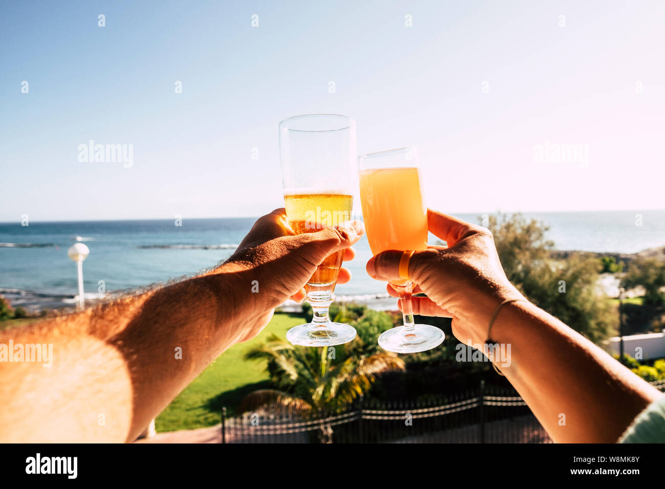 Caucasian couple enjoy and celebrate summer holiday vacation and travel in tropical beach with beer and fruit cocktail together in love and relationsh Stock Photo