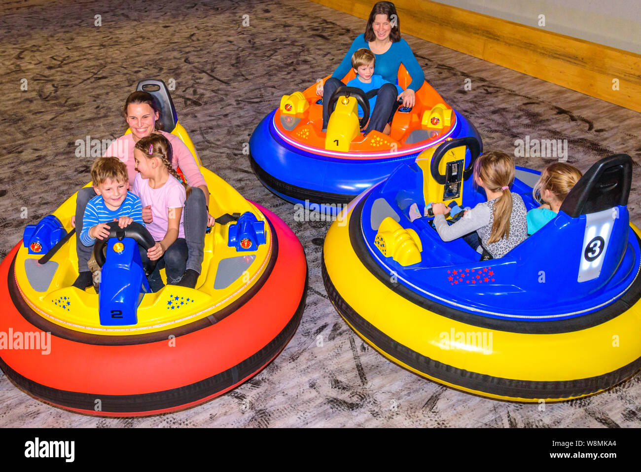 Scooter driving with the kids in indoor playground Stock Photo Alamy
