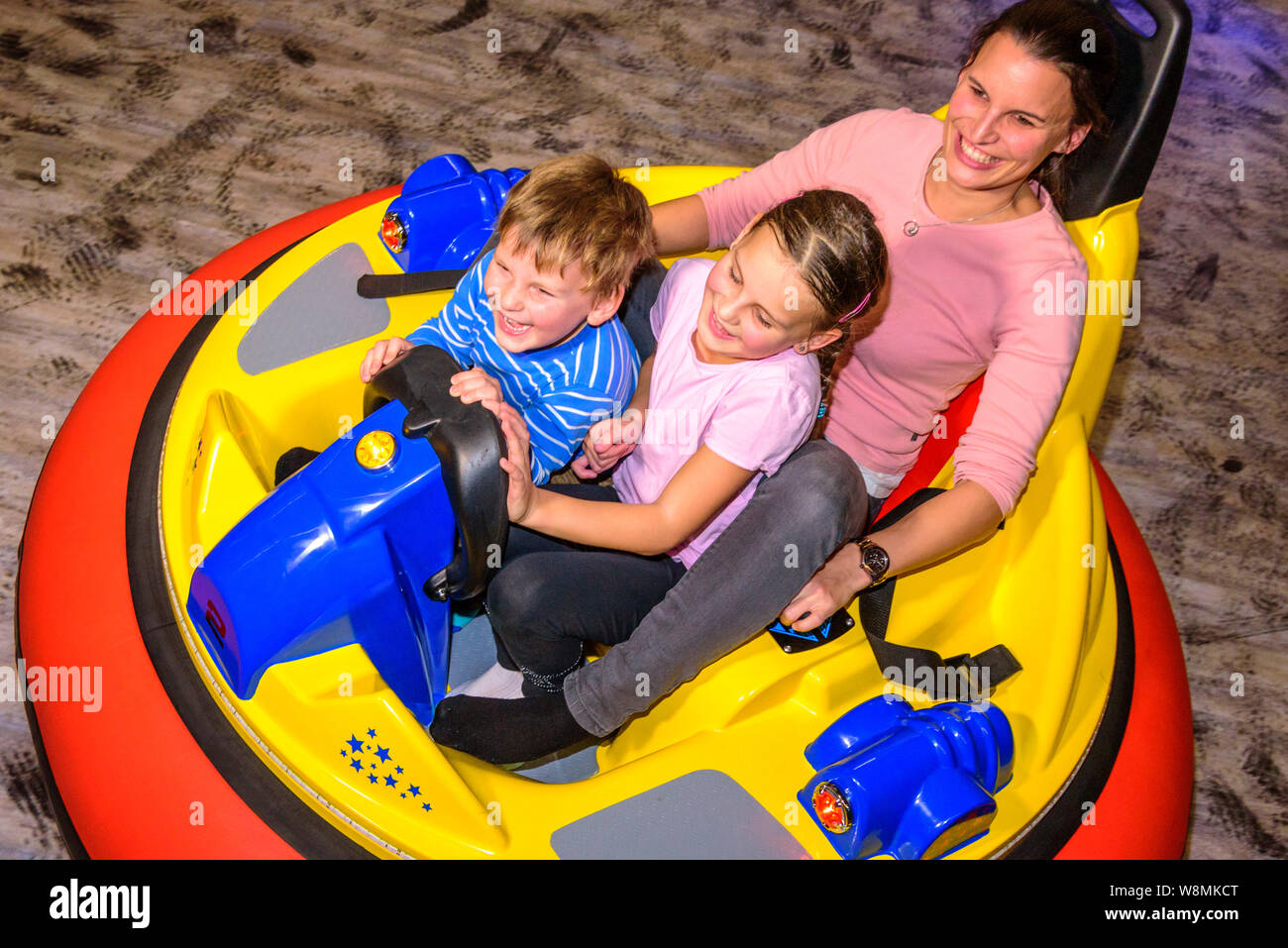 Scooter driving with the kids in indoor playground Stock Photo Alamy