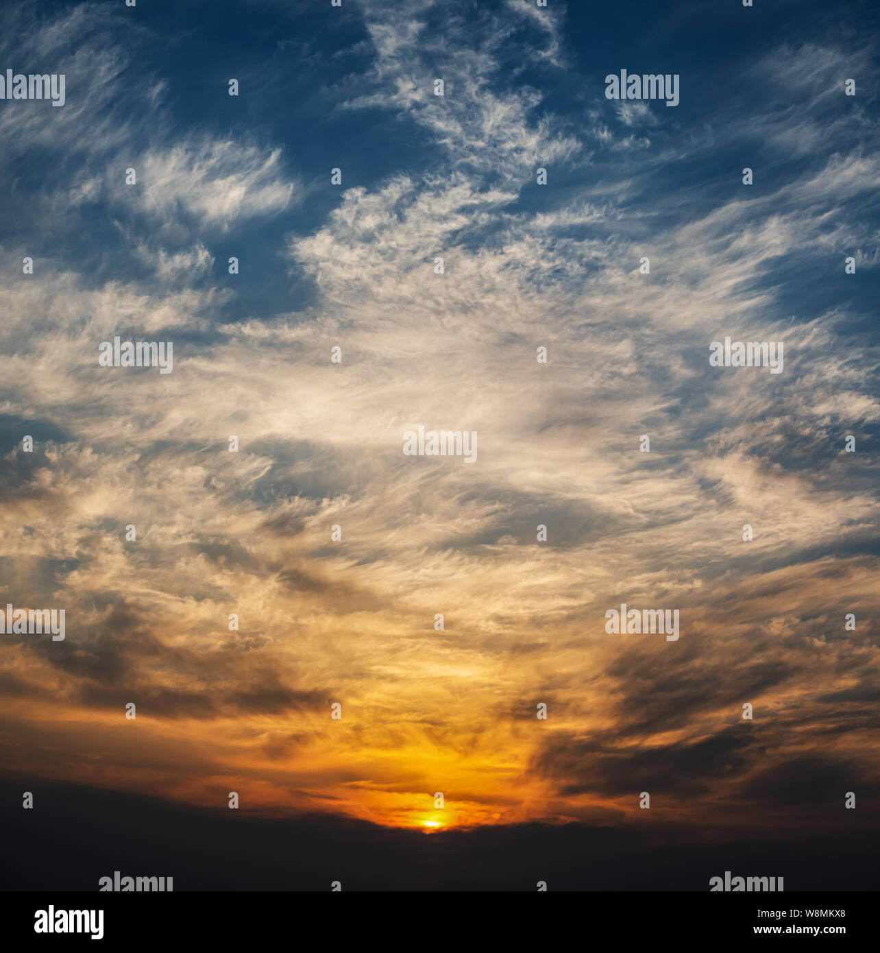 Dramatic sunset sky with orange colored clouds Stock Photo - Alamy
