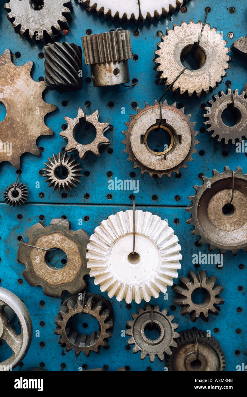 Various of rusty metal gear wheels displayed at blue background Stock Photo