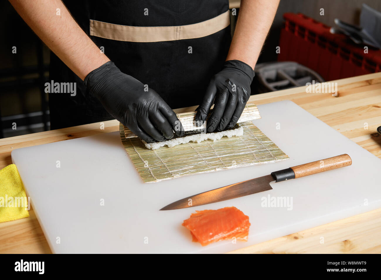 Male hand wrapping salmon rolls Stock Photo Alamy