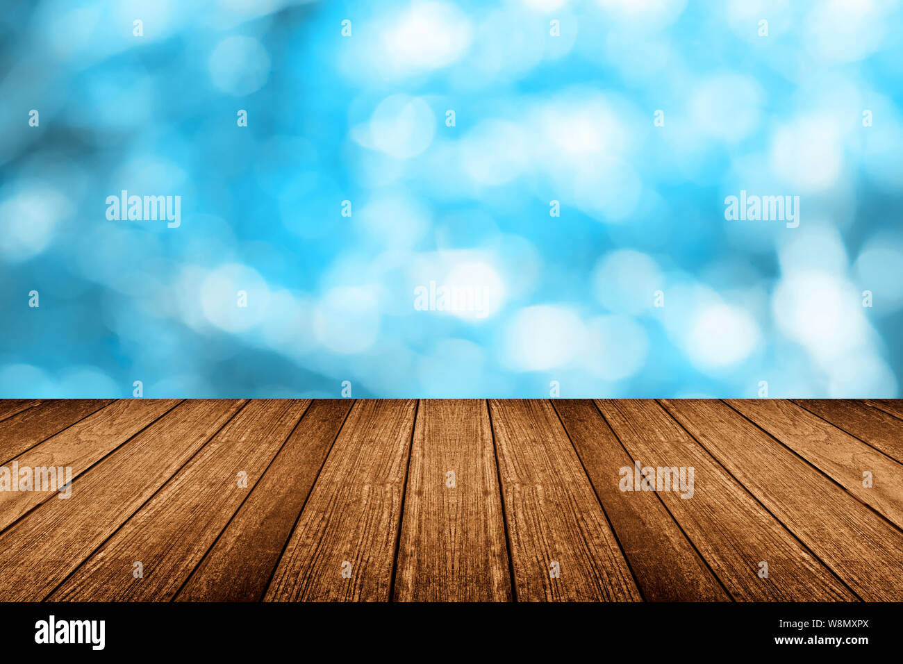 Empty wooden table with light blue bokeh Stock Photo