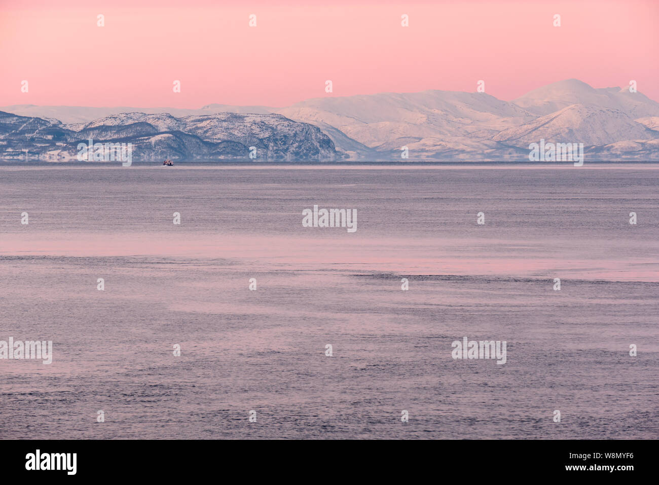 Minimalistic artic landscape under pink sky at sunset, Norway Stock Photo