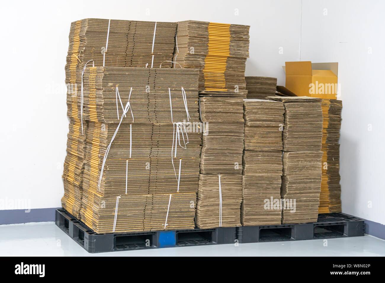 stack of flat pack cardboard boxes for product packaging and delivery