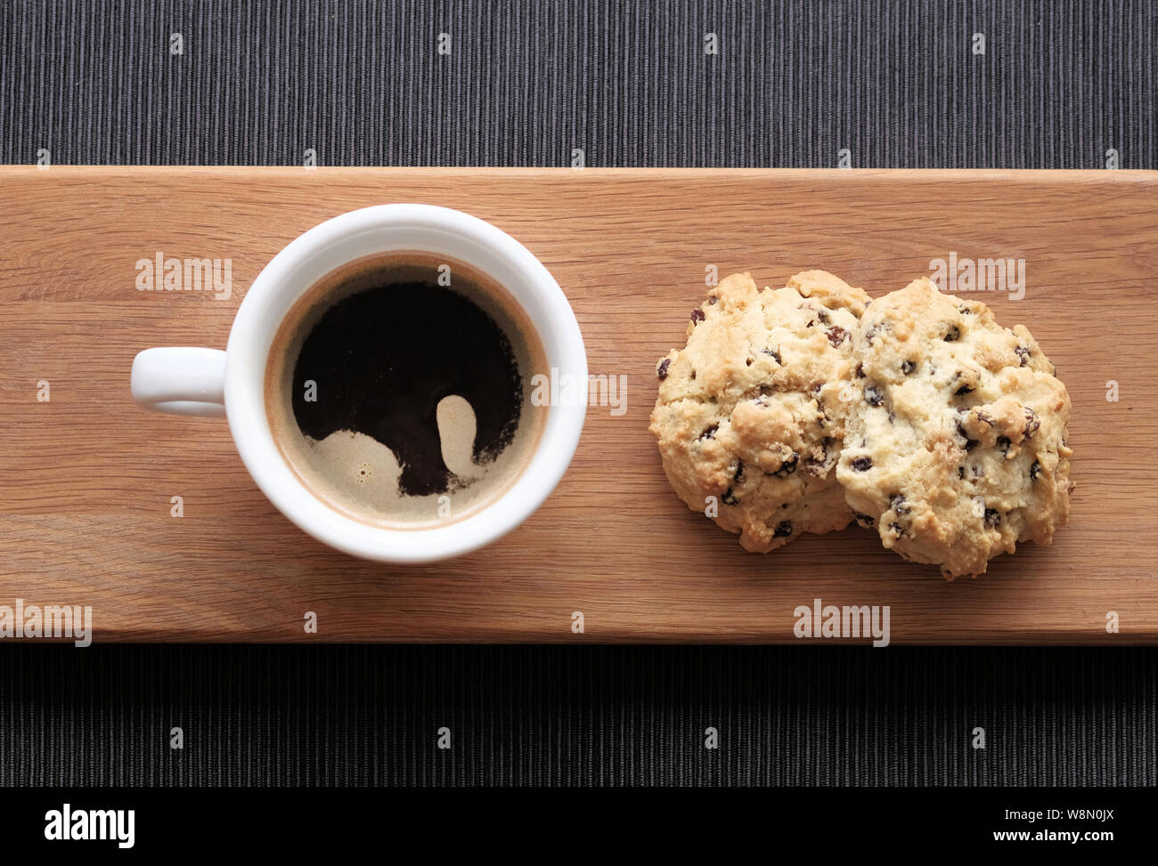 Two freshly made, traditional, English Rock cakes served with a cop of black coffee Stock Photo