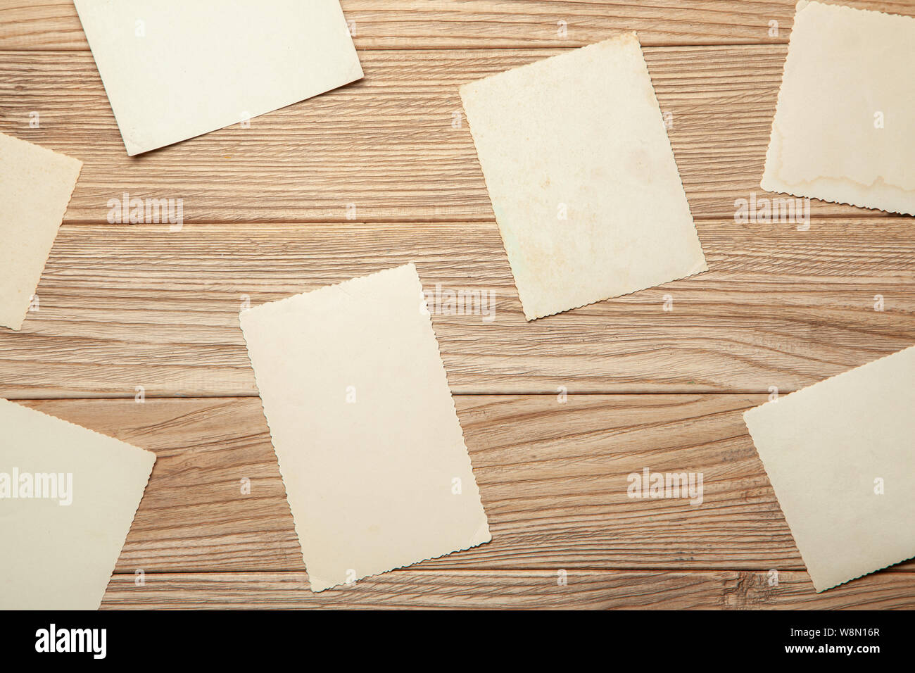 Old photo, blank template for picture, mock-up. Wooden background Stock Photo