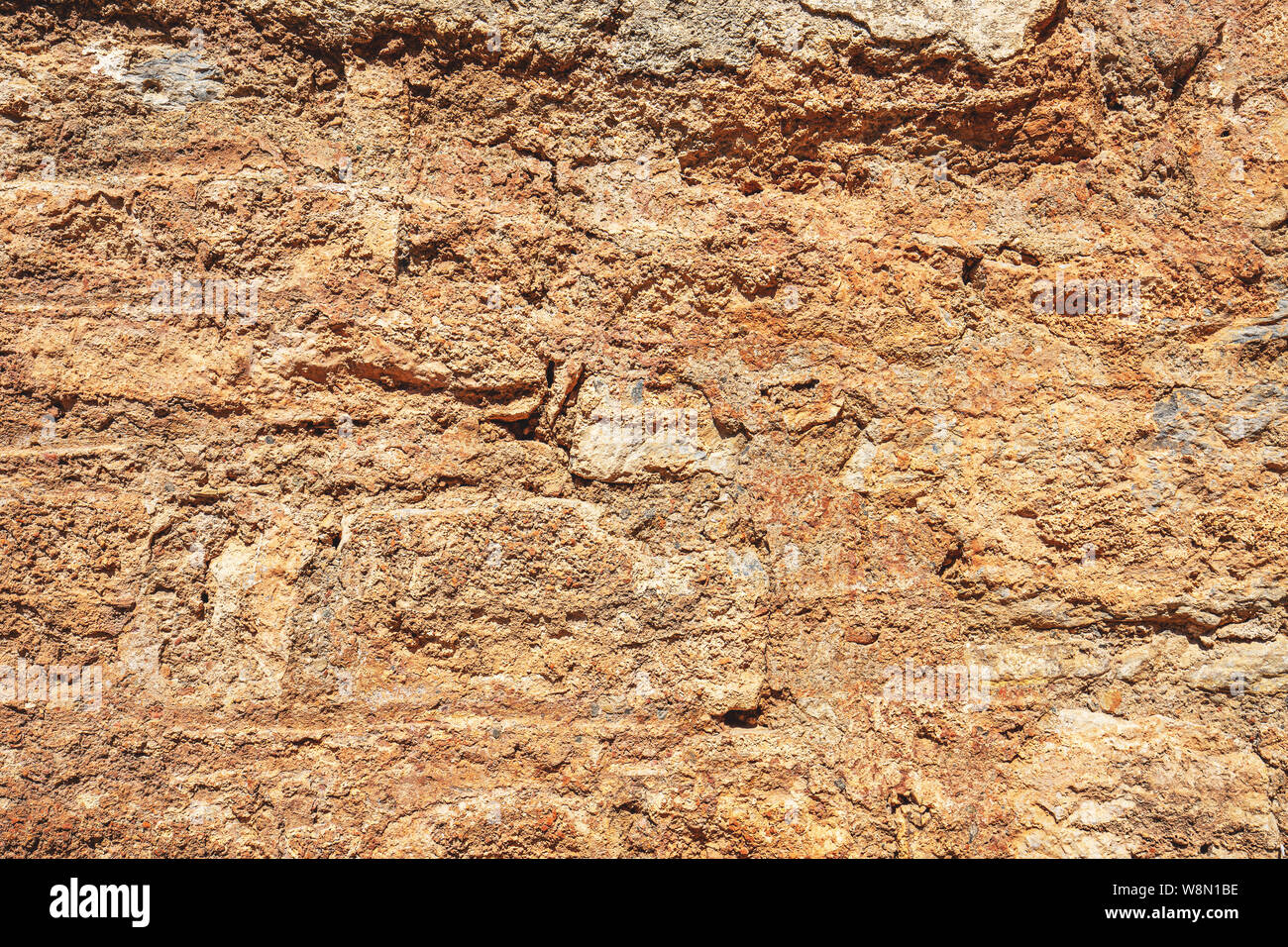 Old damaged stone wall with plaster, ancient wall background Stock Photo