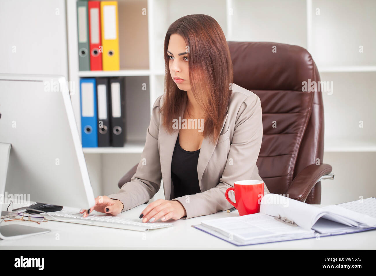 Shot Of Beautiful Young Woman Sitting At Her Work Desk Going