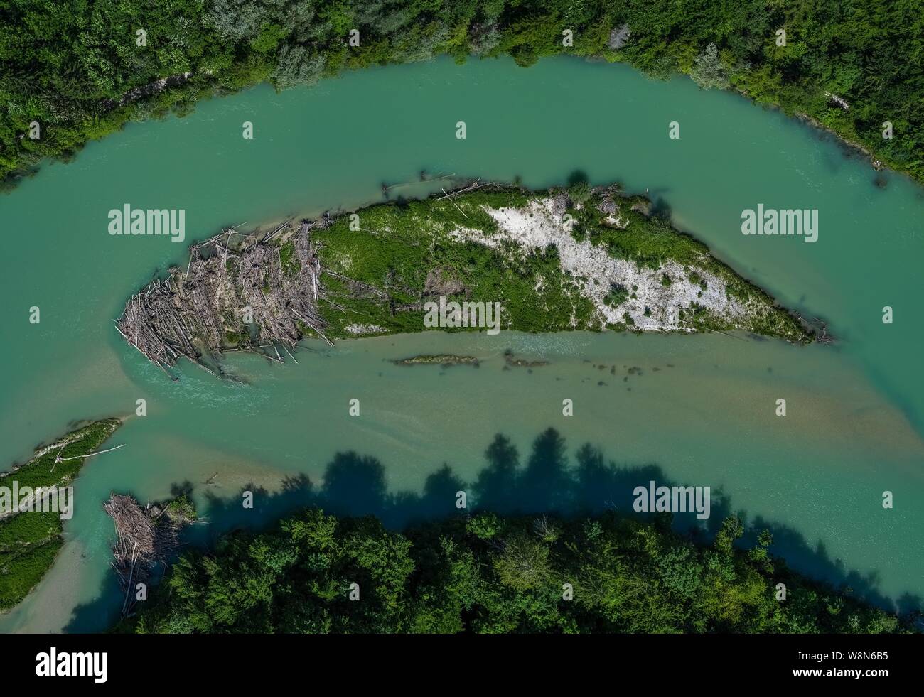 A lonely island in the Isar river in vertical view from a drone Stock Photo