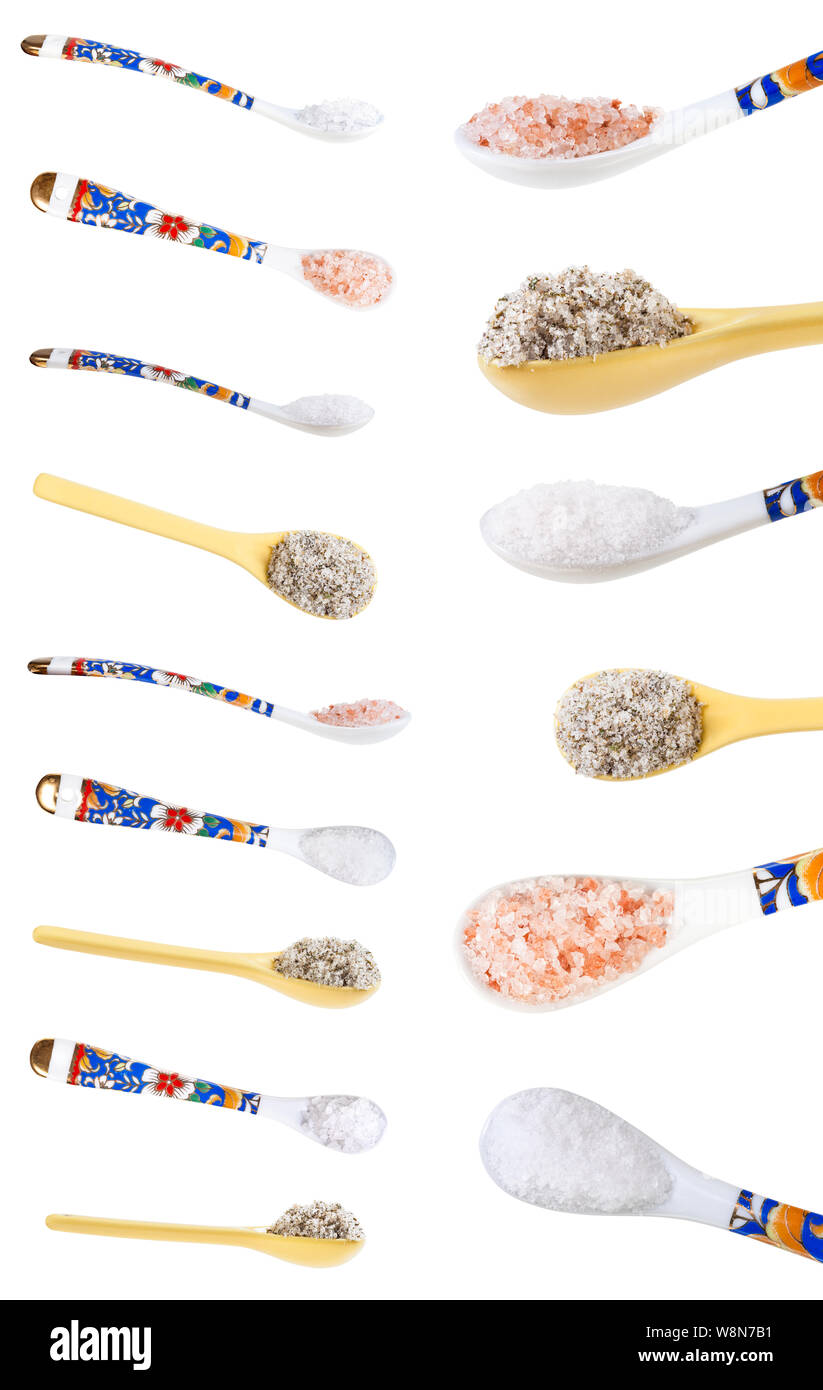 set from ceramic spoons with various salts isolated on white background Stock Photo