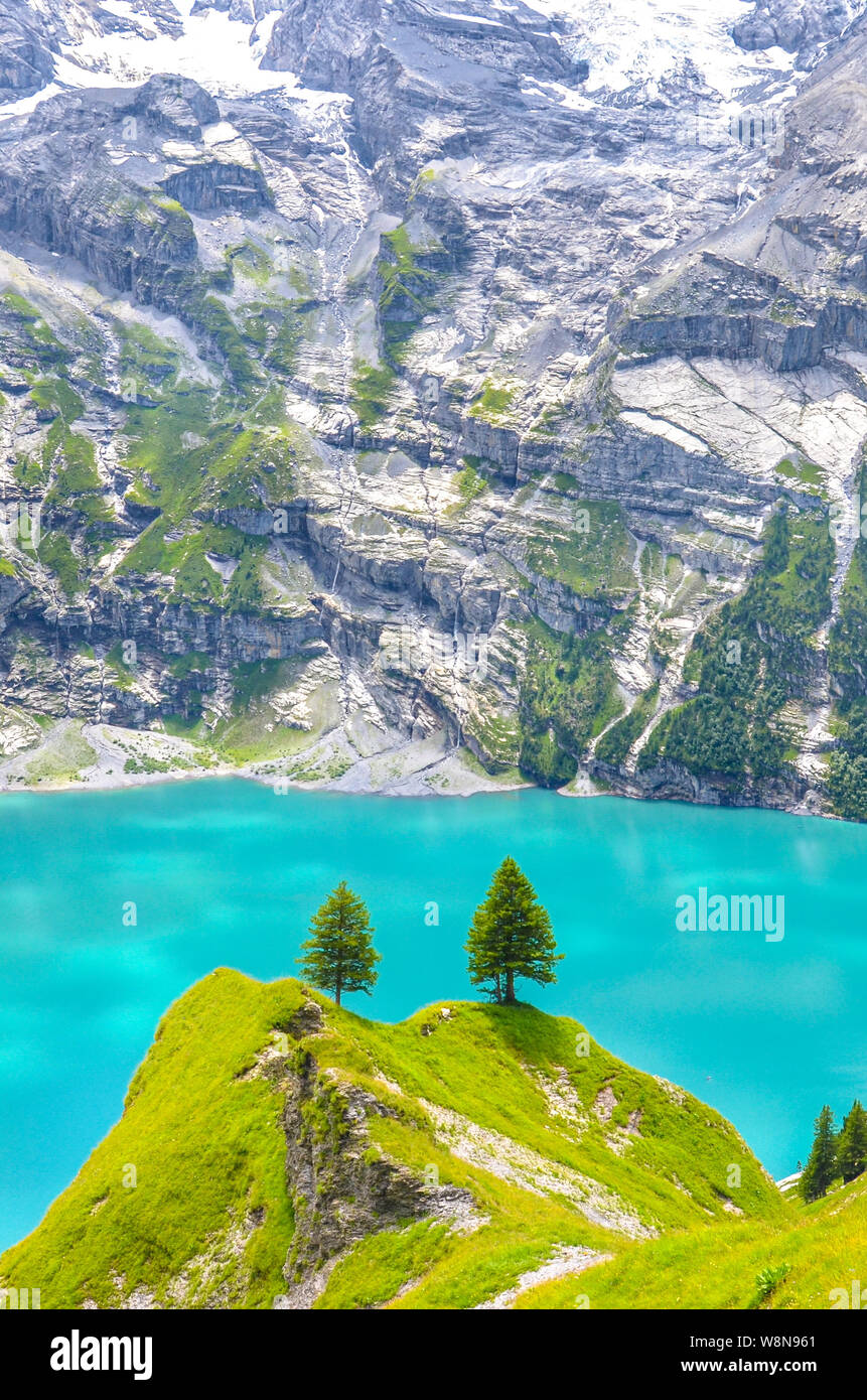 Vertical photo of Oeschinensee, Oeschinen Lake by Kandersteg, Switzerland. Turquoise  lake with mountains and steep rocks in background. Swiss Alps. Sw Stock  Photo - Alamy