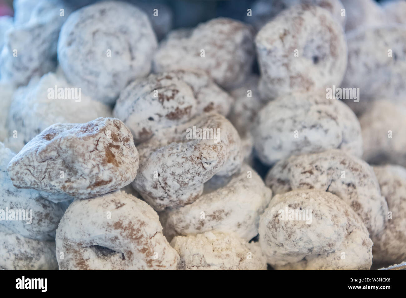Powdered Sugar Covers Fresh Mini Donuts in pile Stock Photo