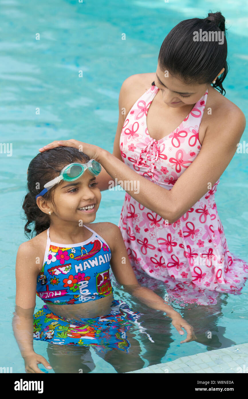 Mother and daughter enjoying in a swimming pool Stock Photo - Alamy