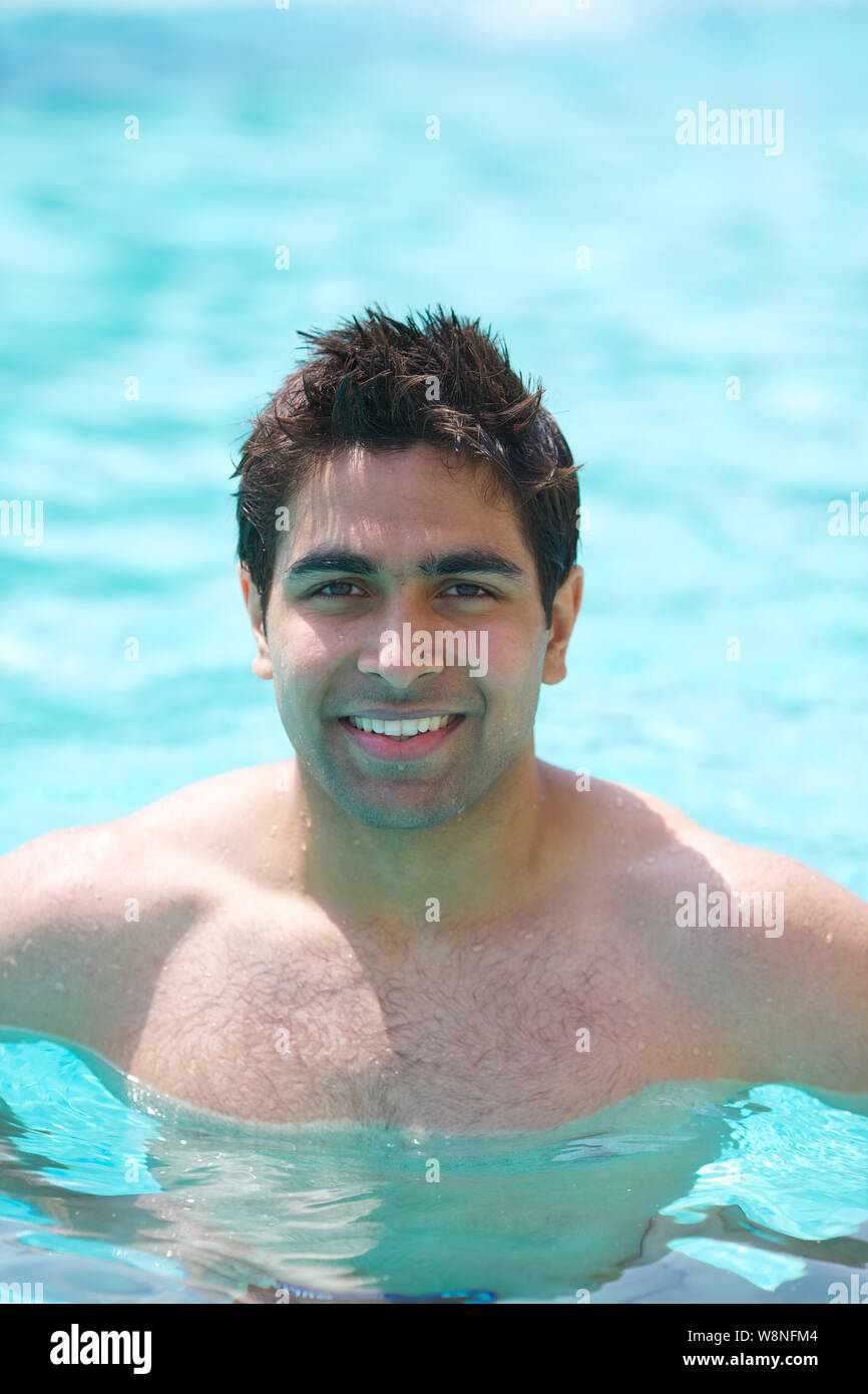 Young man enjoying in a swimming pool Stock Photo