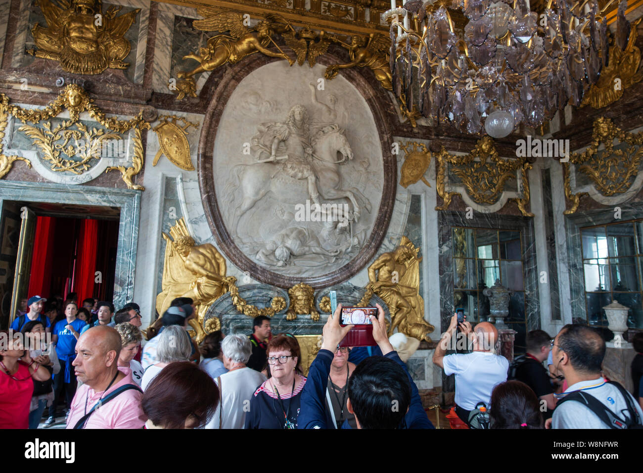 Crowds of tourists within the War Drawing Room in the King’s State Apartment - Palace of Versailles, Yvelines, Île-de-France region of France Stock Photo