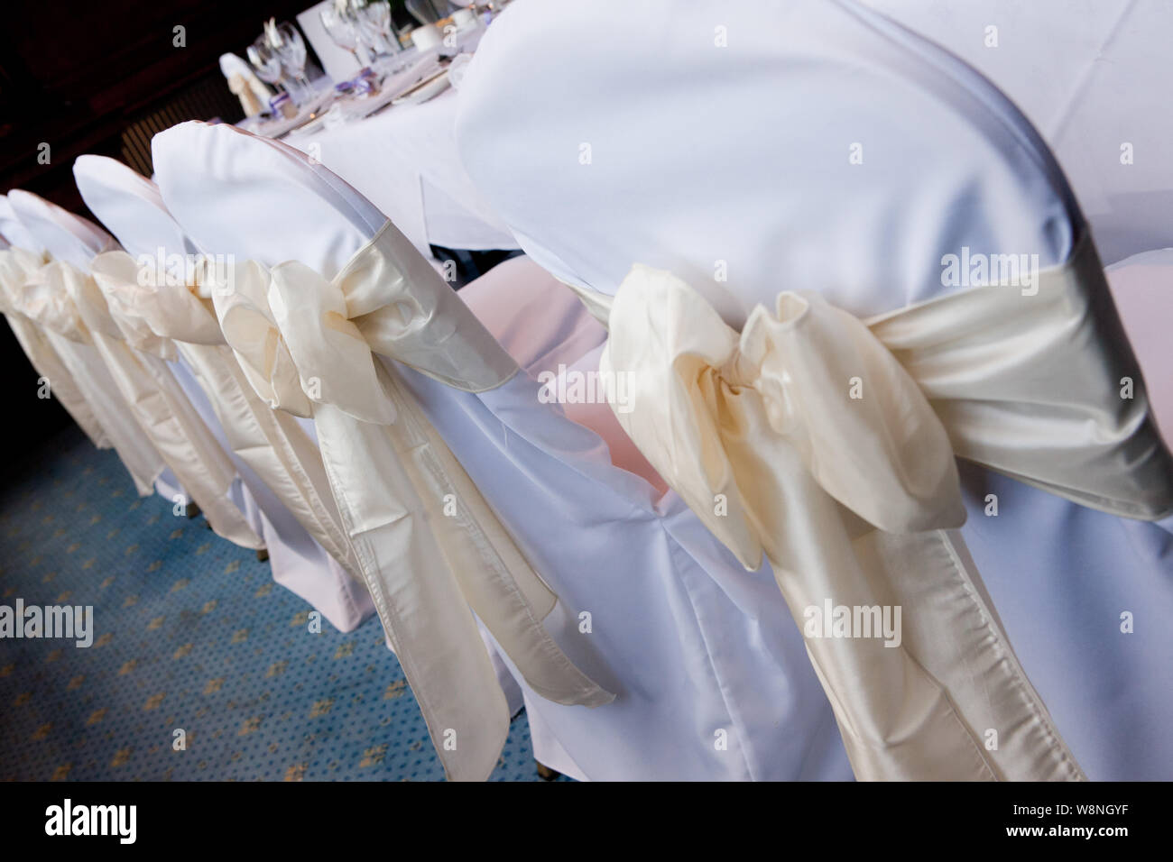 White Chair Covers with a Cream Sating Bow Stock Photo