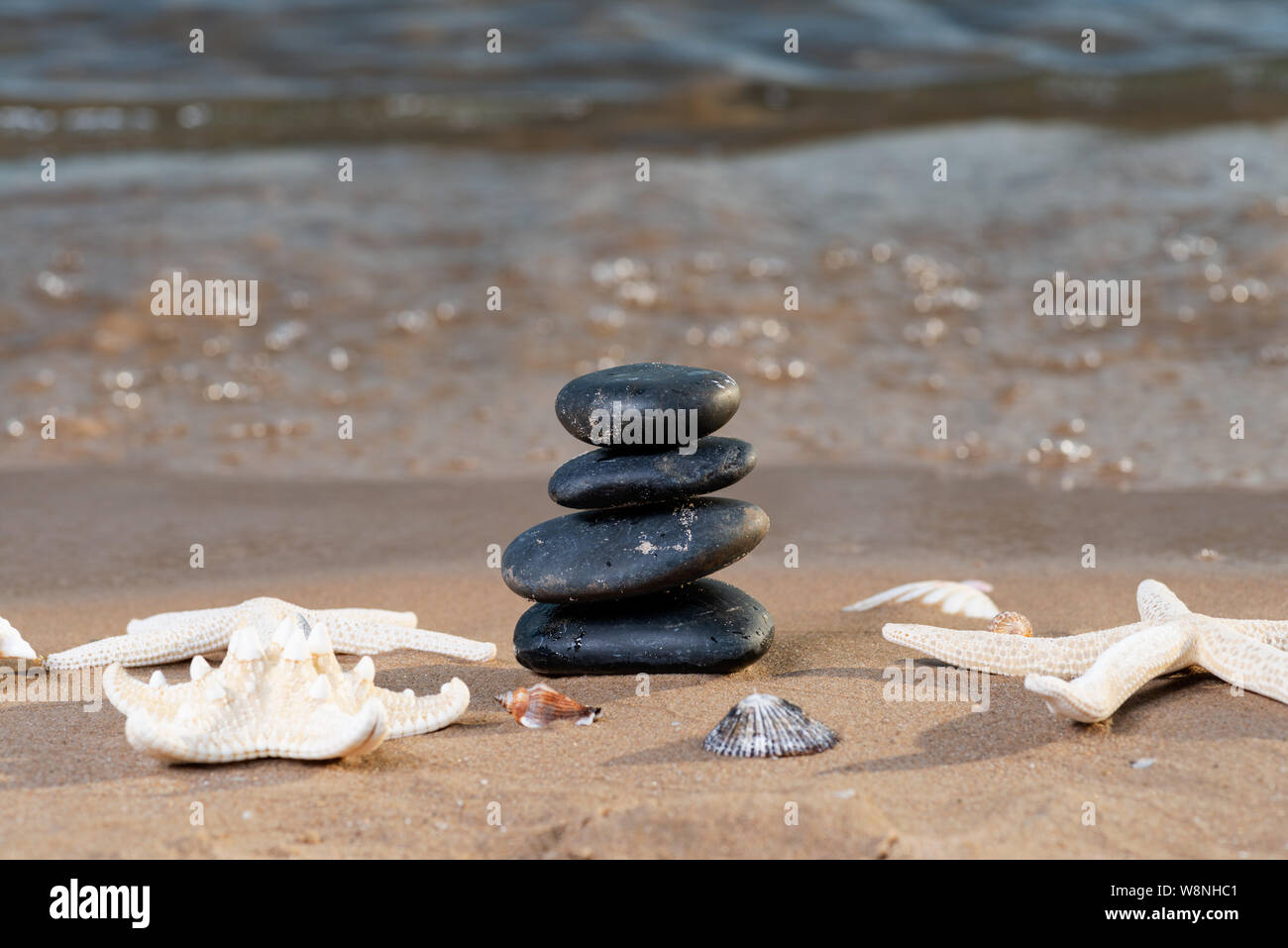 Spa composition - stacked Basalt Stones, Seashells and Sea Stars on the ...