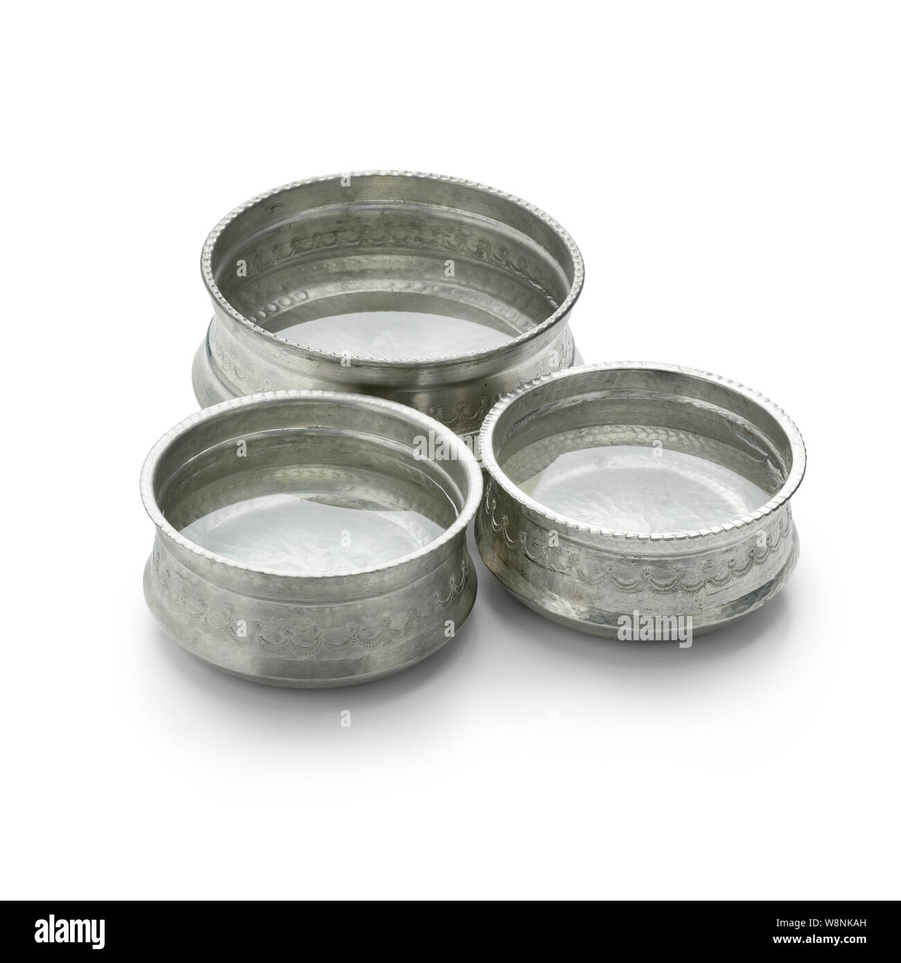 Decorated silver colored metal Hammam water bowls with water isolated on white background Stock Photo