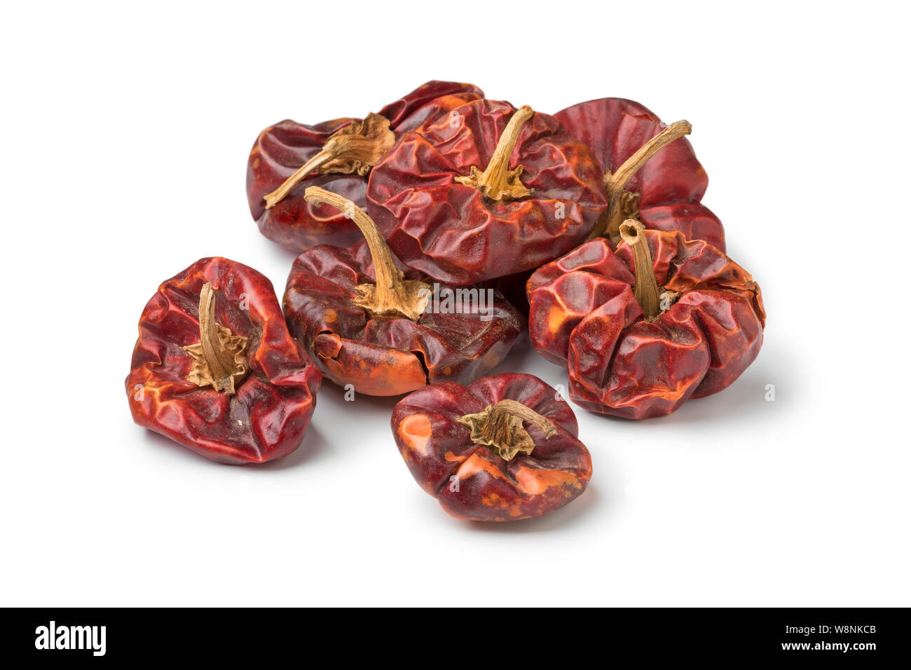 Heap of dried red bell peppers isolated on white background Stock Photo
