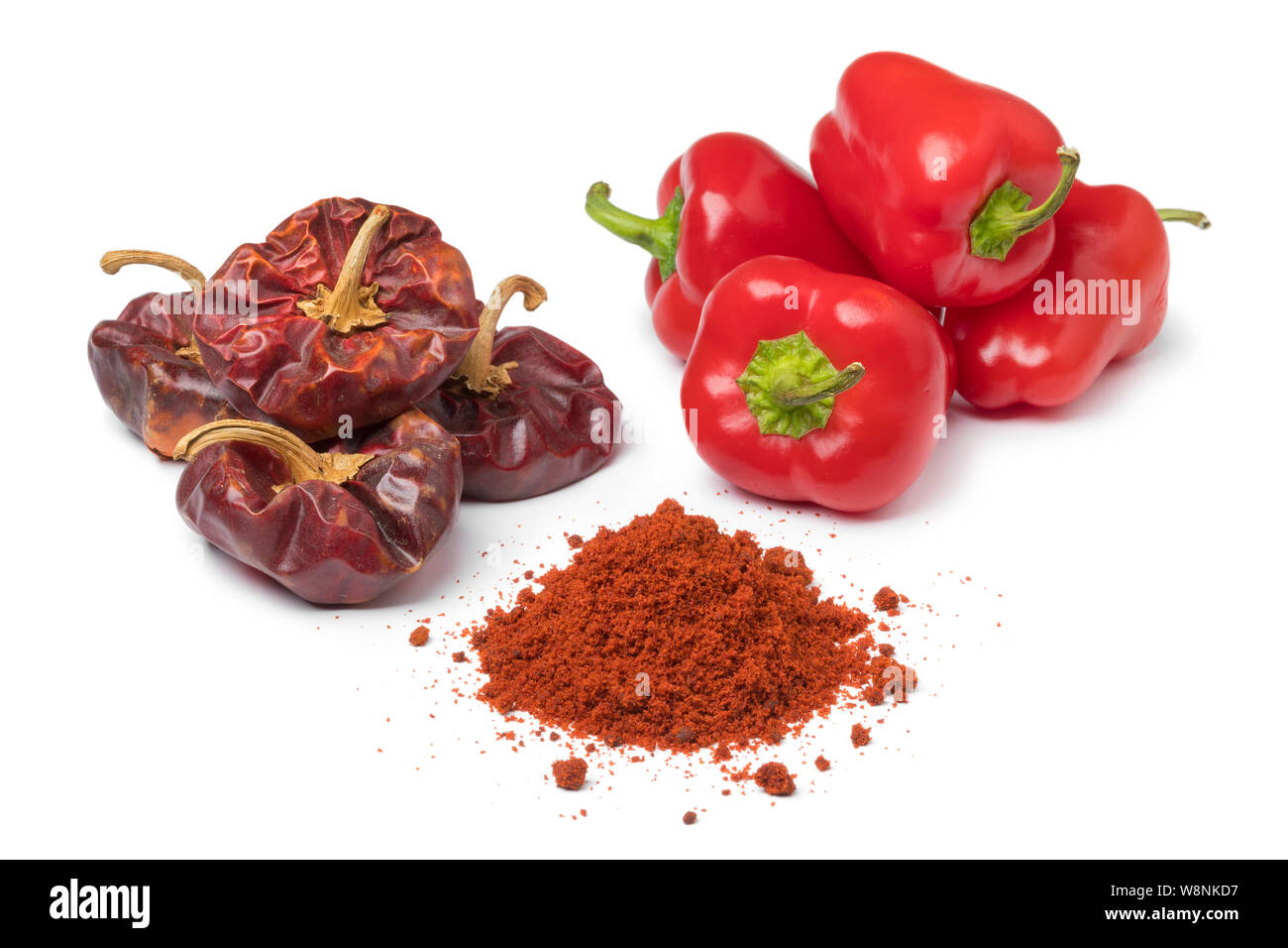 Dried and fresh red bell peppers and a heap of powder isolated on white background Stock Photo