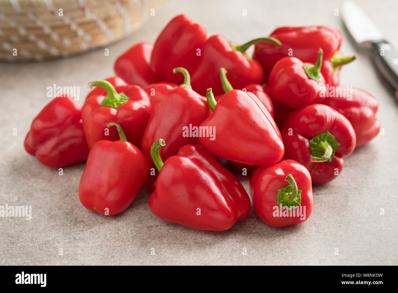 Heap of fresh raw mini red bell peppers ready to cook Stock Photo