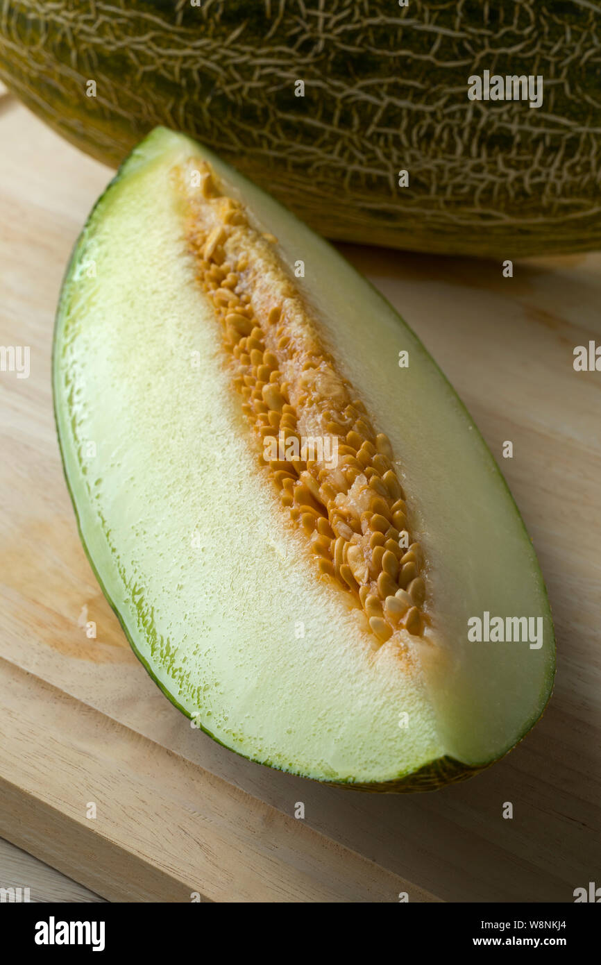 Piece of fresh ripe juicy Piel de sapo melon and seeds Stock Photo