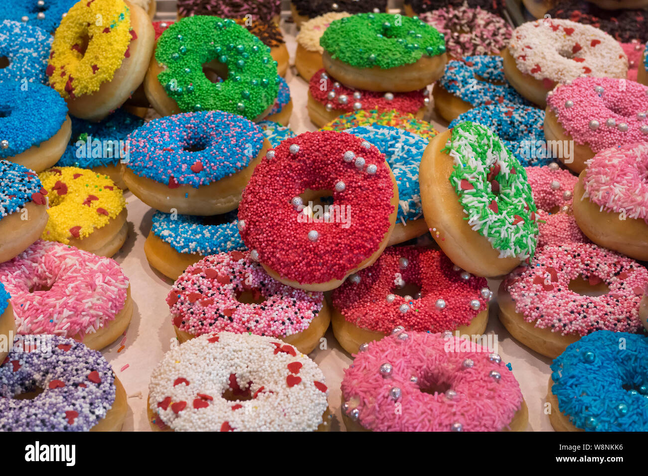 Festive decorated multi colored fresh donuts Stock Photo
