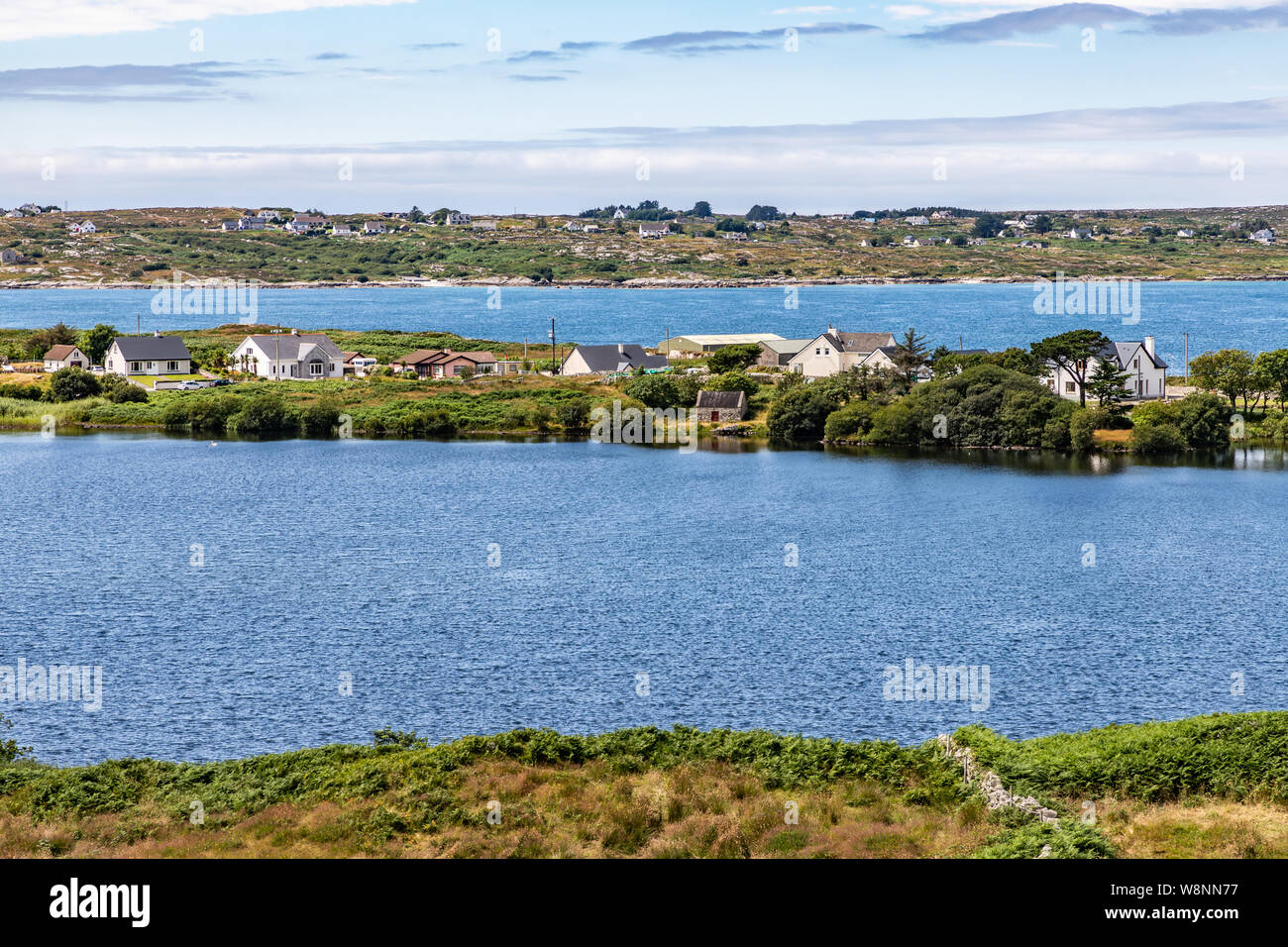 Bay with farm field and houses in Carraroe, Conemara, Galway, Ireland