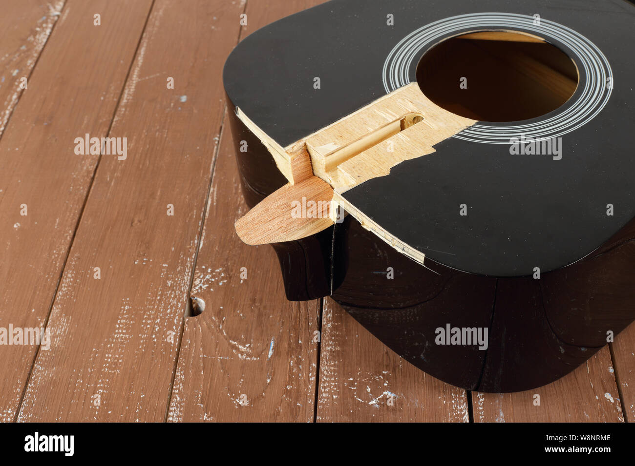 Guitar repair and service - Fragment broken sound board acoustic guitar wooden background Stock Photo