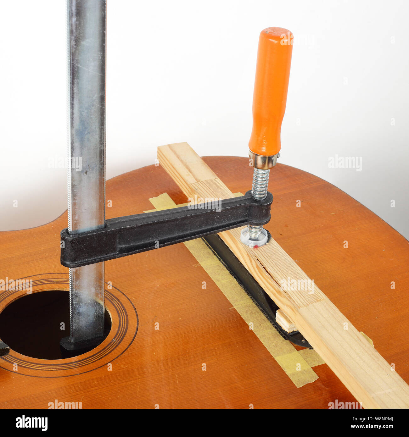 Guitar repair and service - Glue fix Acoustic Guitar Bridge Stock Photo -  Alamy