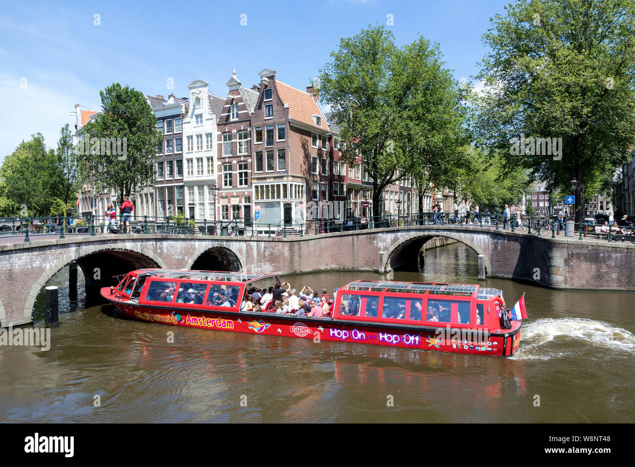 Amsterdam canal boat BZN 5 of City Sightseeing Amsterdam at Keizersgracht/ Leidsegracht intersection. Stock Photo