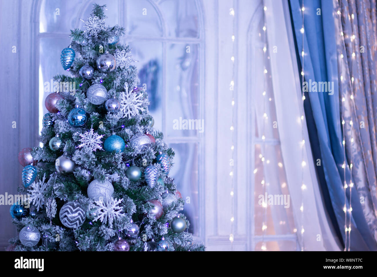 Christmas tree decorated with blue balls and snowflakes Stock Photo - Alamy