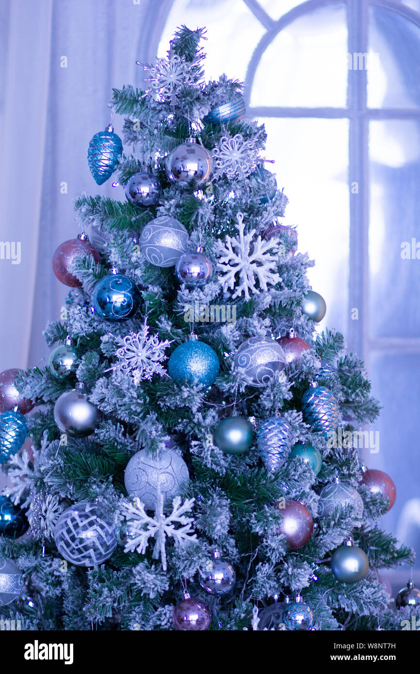 Christmas tree decorated with blue balls and snowflakes Stock Photo Alamy
