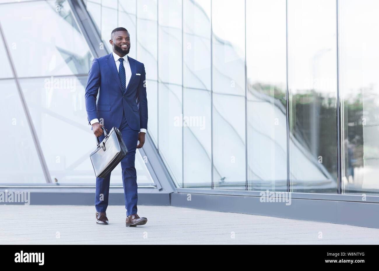 Successful Black Businessman With Briefcase Walking In Urban Area Stock