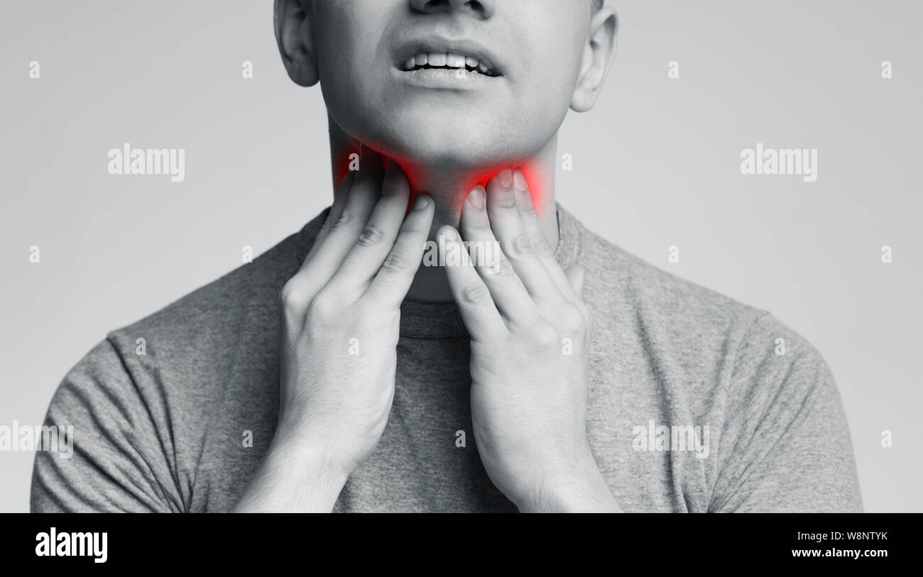 Man with thyroid gland problem, touching his neck Stock Photo Alamy