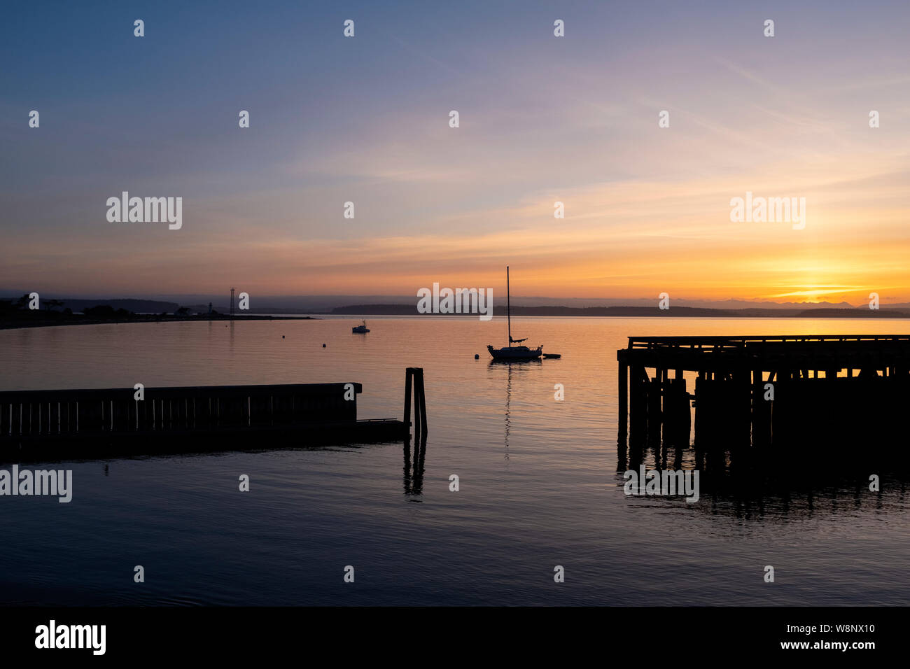 WA17279-00...WASHINGTON - Sunrise over Port Townsend Bay with Mount Baker in the distance. Stock Photo