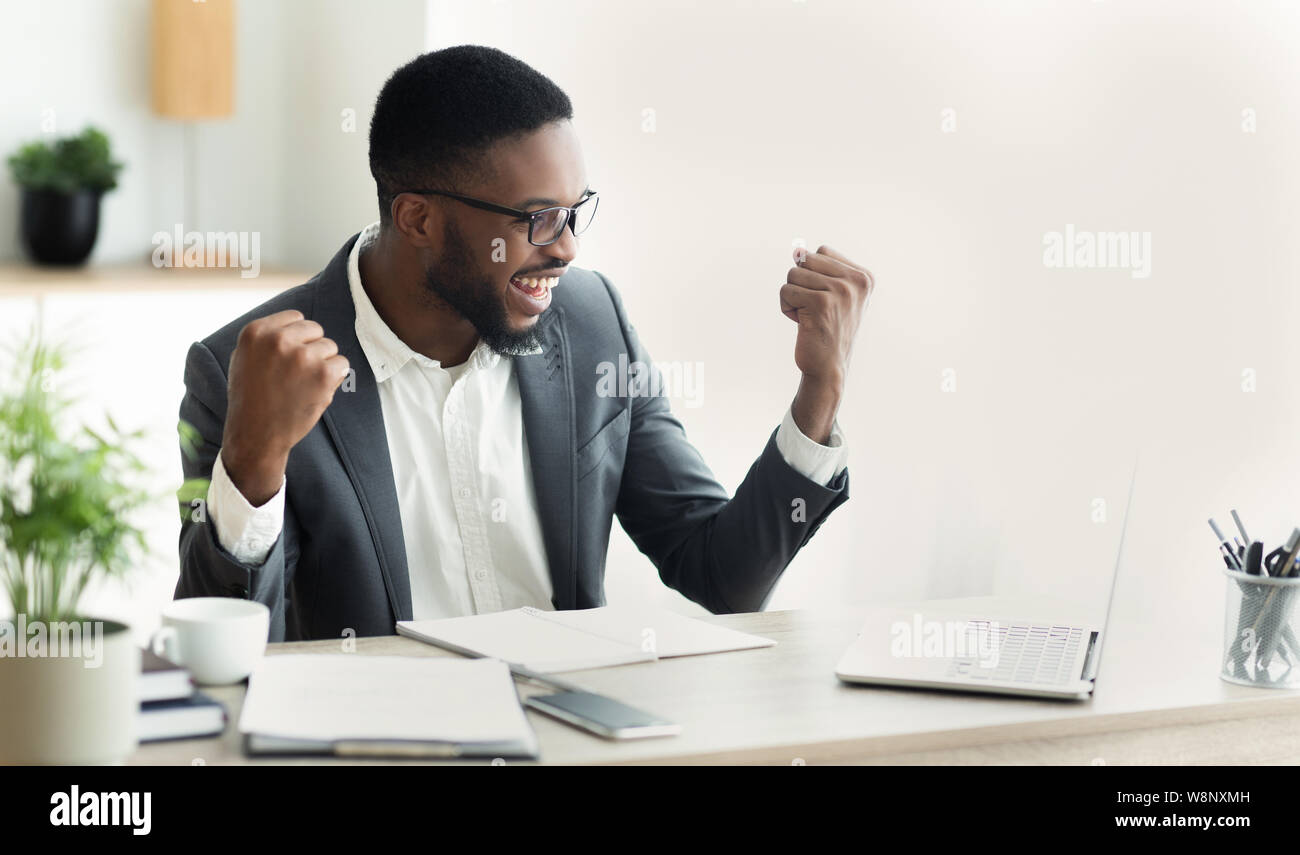 Young black businessman celebrating success with raised arms Stock ...