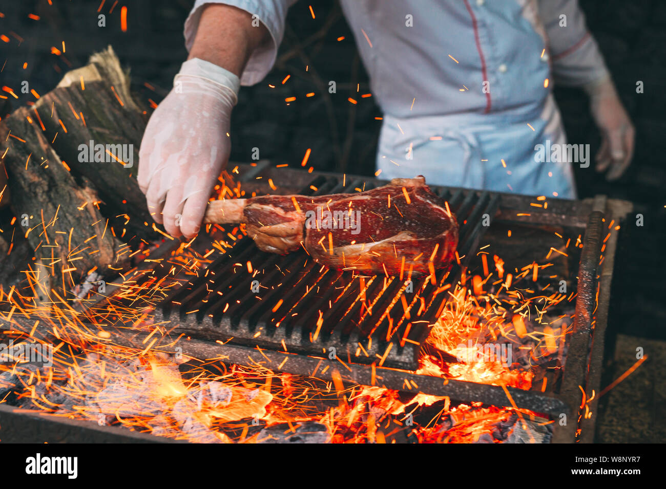 Cook turns meat on grill hi-res stock photography and images - Alamy
