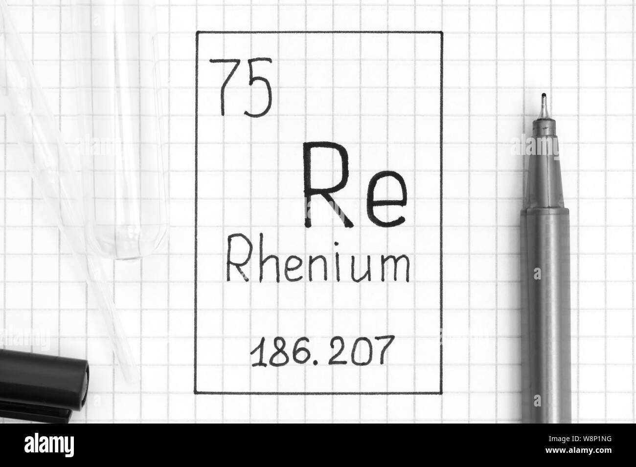 The Periodic table of elements. Handwriting chemical element Rhenium Re with black pen, test tube and pipette. Close-up. Stock Photo