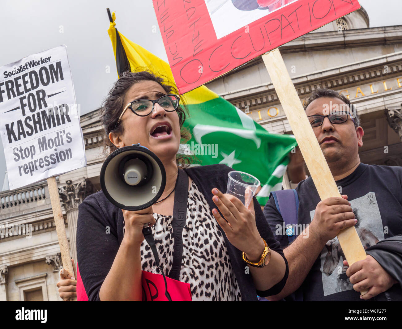 London, UK. 10th August 2019. A woman calls for freedom as Kashmiris protest in Trafalgar Square against India's President Modi who revoked Article 370 of the Indian Constitution which guaranteed significant autonomy to the Muslim-majority state of Kashmir after the Independence partition of India and Pakistan. Kashmiris have been calling for independence, with armed revolt since 1989 suppressed by torture, deliberate blinding and killings by a huge Indian occupying force. They call Modi a Hindu fascist who has united the country against India.Peter Marshall/Alamy Live News Stock Photo