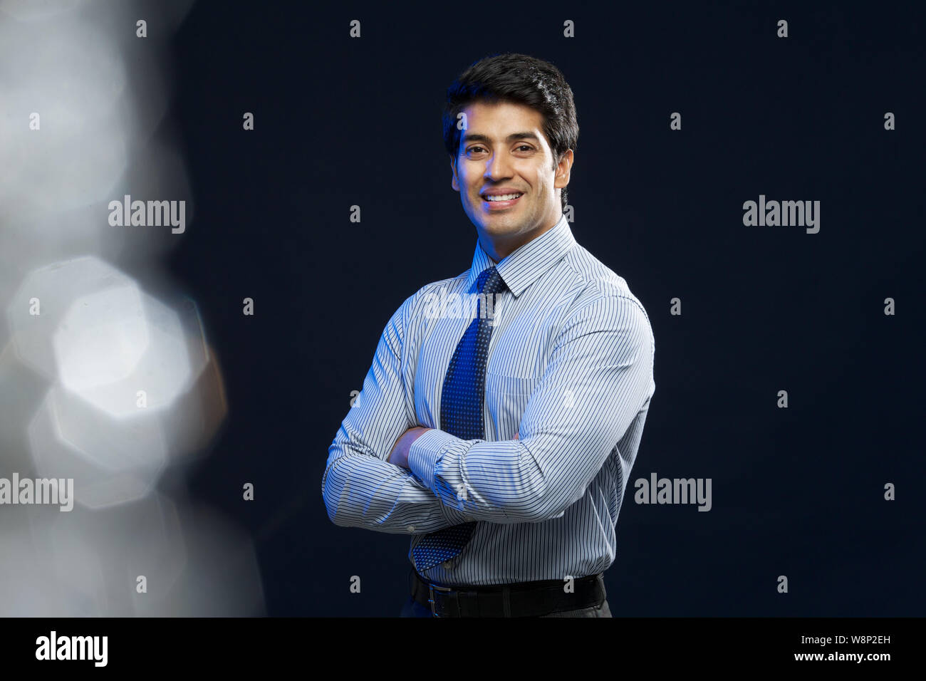 Portrait of a businessman smiling with his arms crossed Stock Photo - Alamy