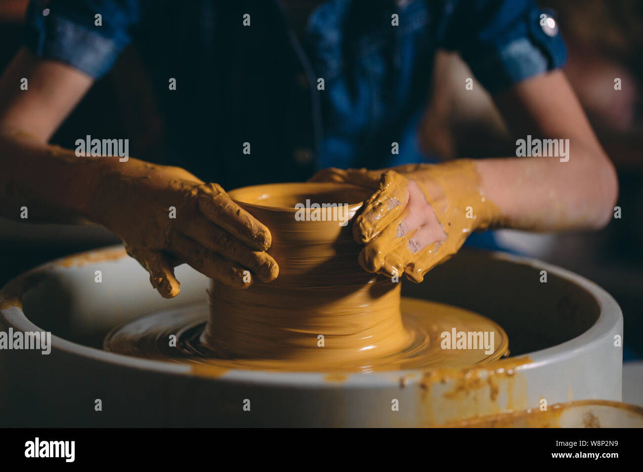 Pottery A little girl makes a vase of clay. Clay modeling