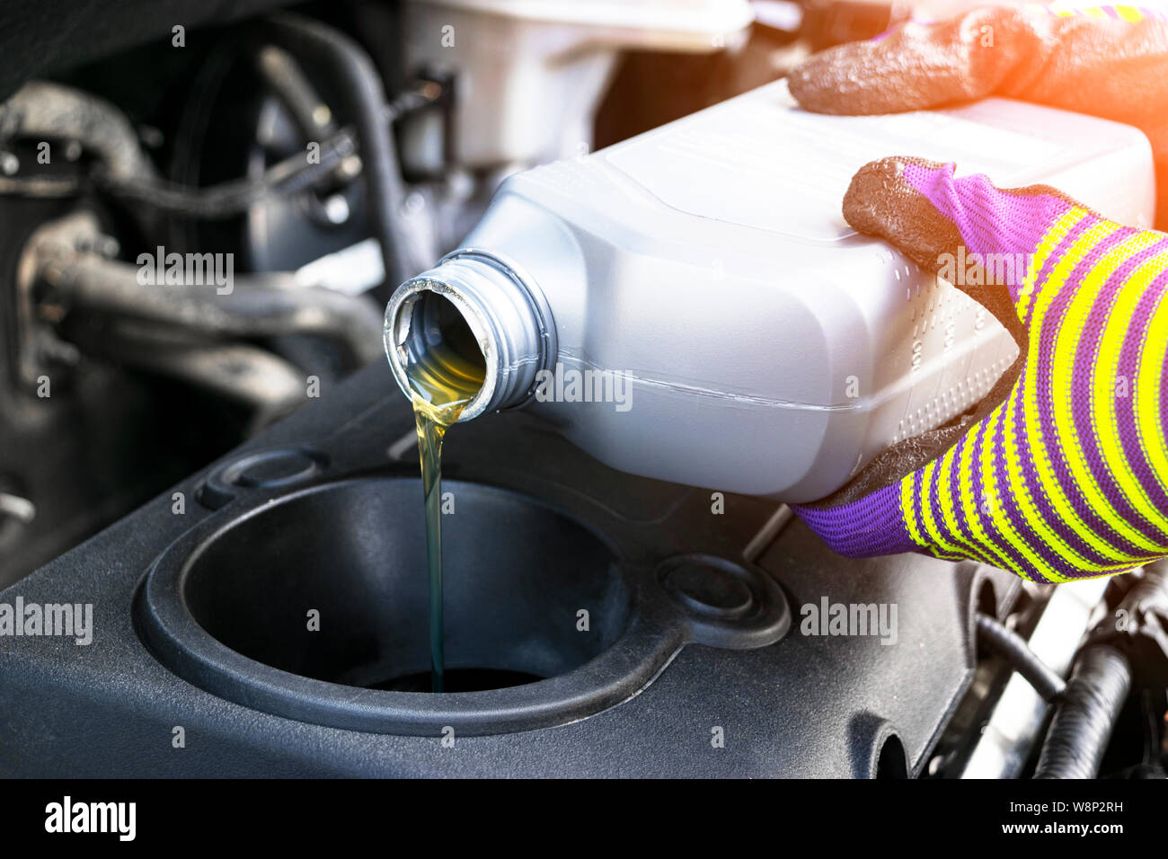 Change the Oil. Hand mechanic in repairing car. Close up oil for car