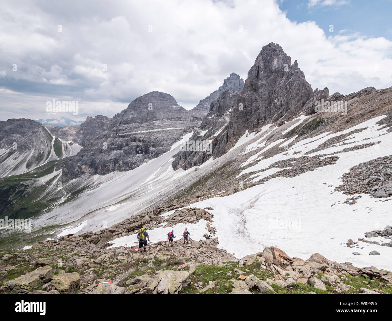 Trekkers undertaking the Gschnitztal Runde Tour enjoy the rugged scenery of the Tribulaun mountains near the Tribulaun hut refuge Stock Photo