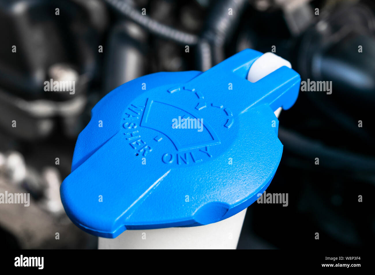 Car windshield wiper cleaning spray water reservoir blue bottle cap in