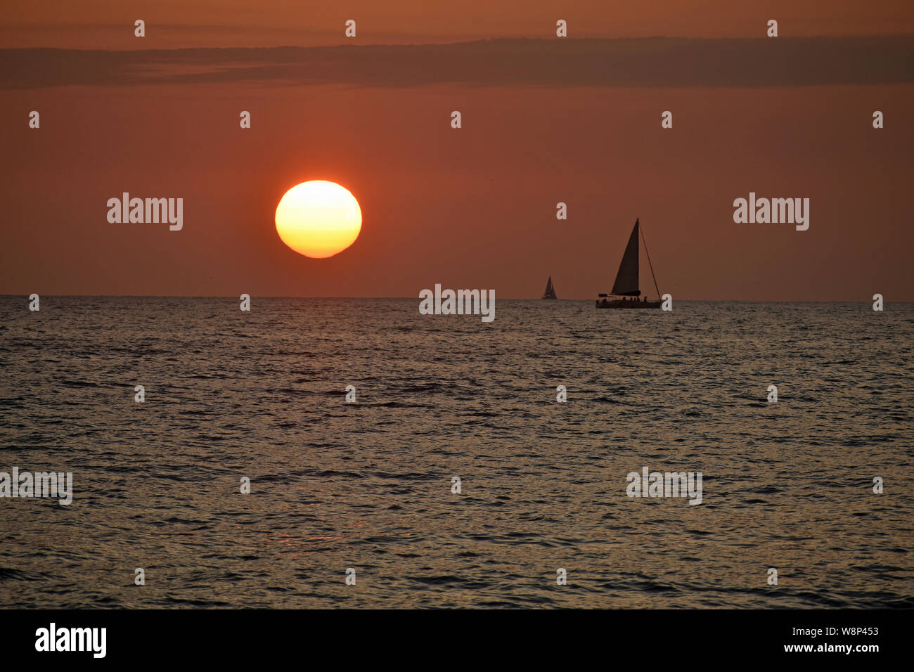 Sailboats at Sunset Stock Photo Alamy